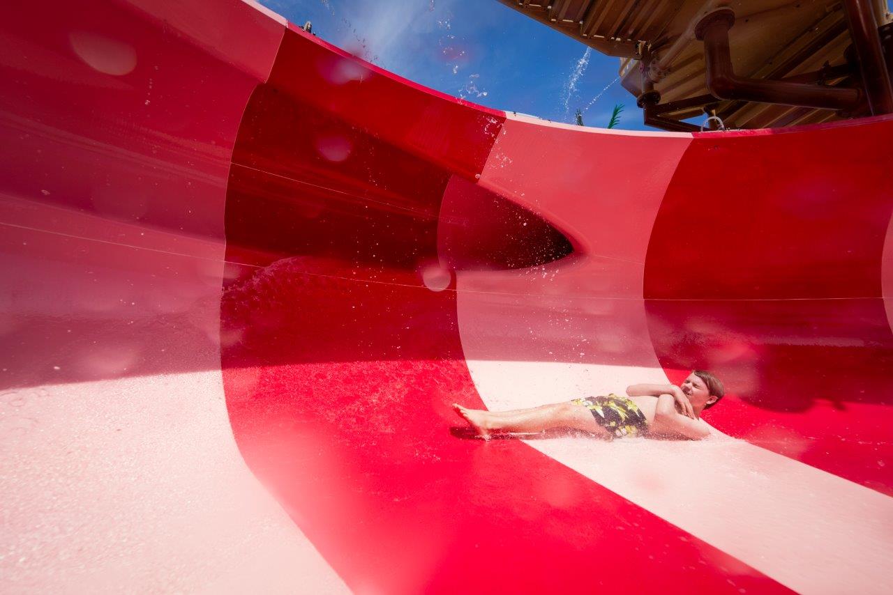 Kid on a red body slide