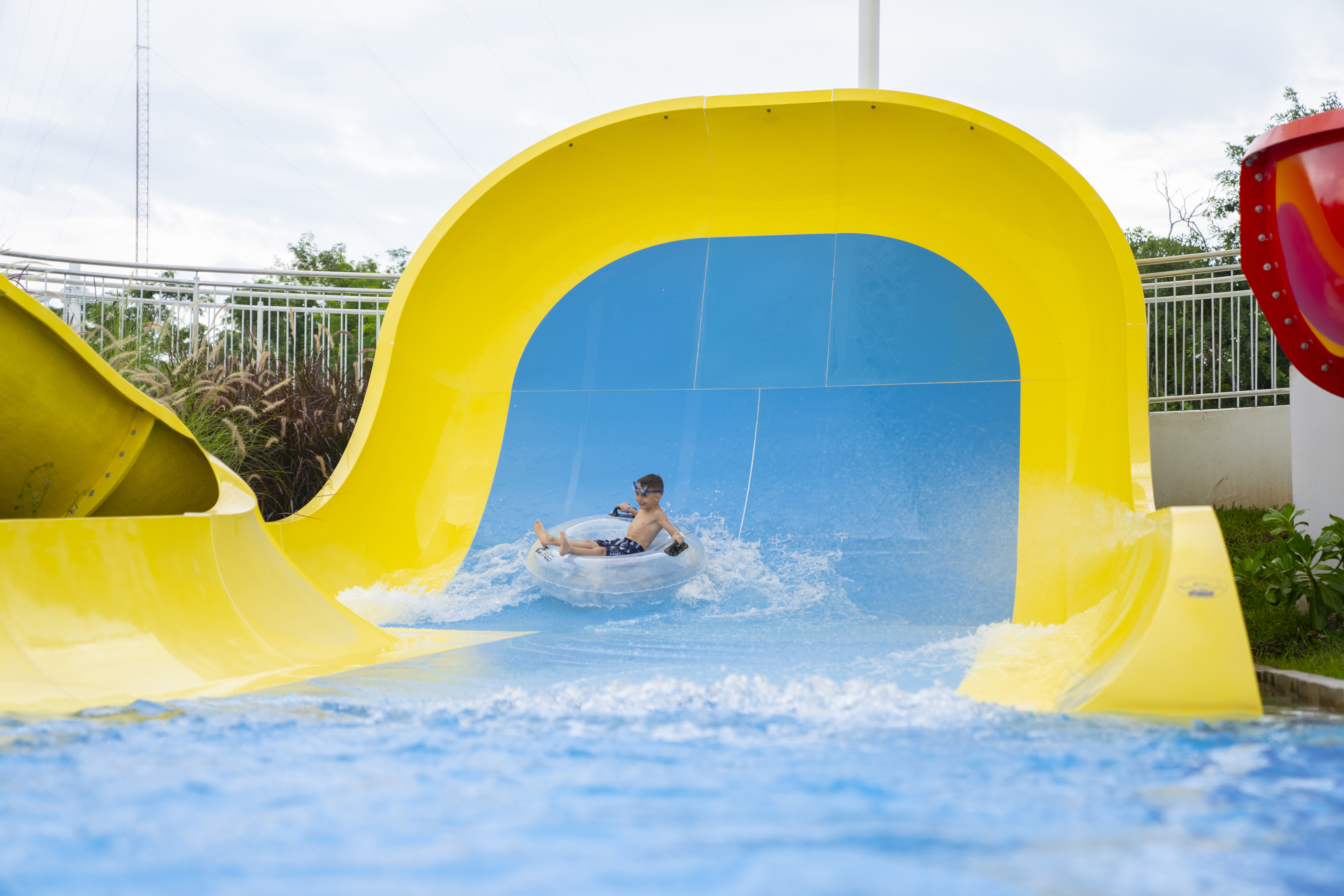 A boy in an inner tube on a Mini Boomerango water slide