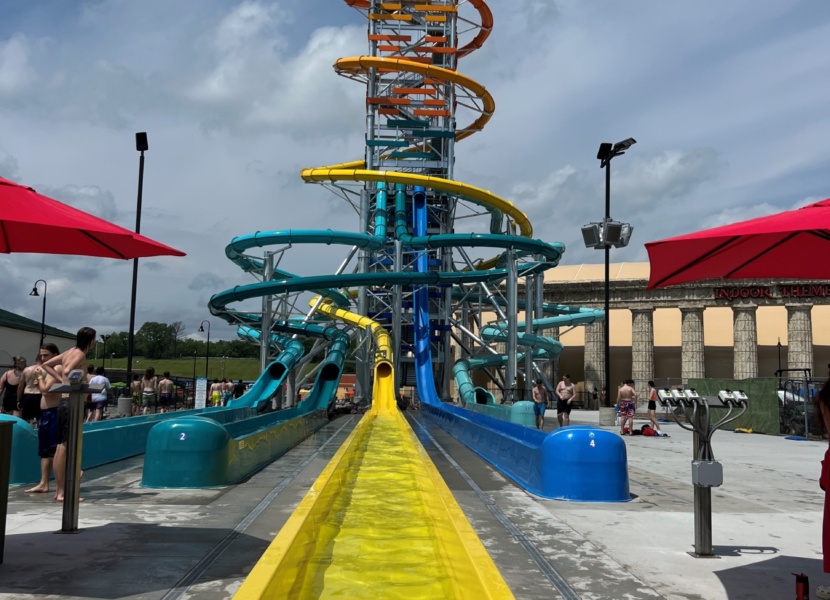 Very tall tower with colorful water slides wrapped around it.